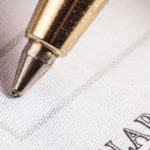 closeup of pen writing on check