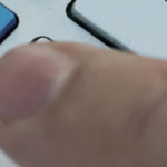 person reaching towards keyboard key that says FAQ