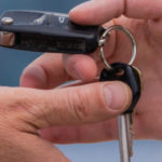 person handing over car keys