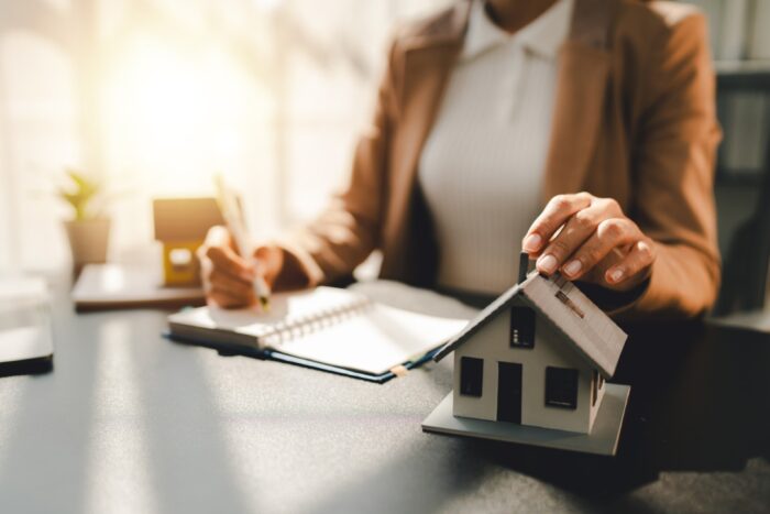 A woman making notes regarding a mortgage