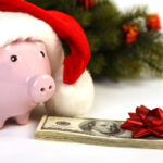 Piggy bank with Santa hat and money, christmas tree with a holiday budget